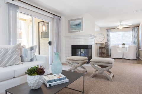a living room with a white couch and a fireplace